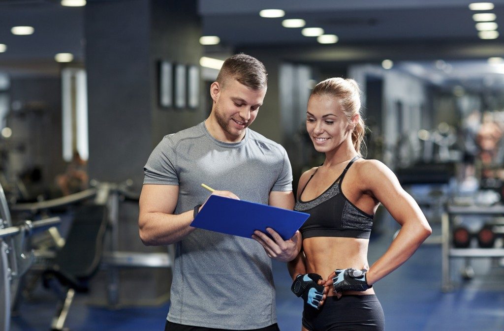 woman consulting with her personal trainer