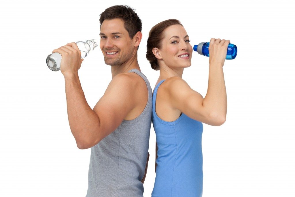sporty couple drinking water