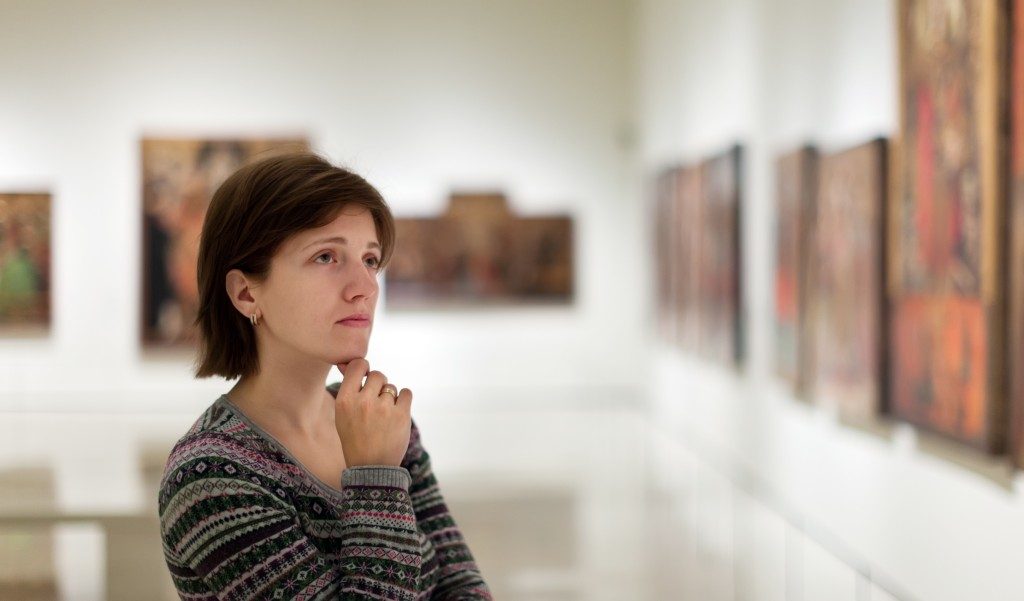 woman looking at art in a museum