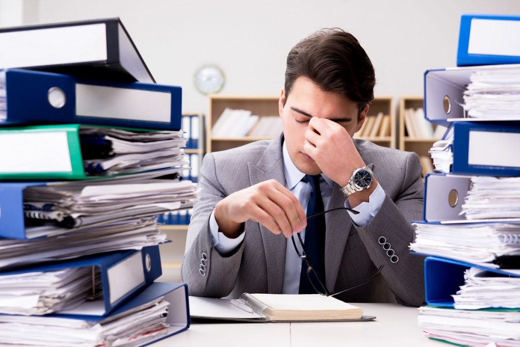 man feeling stressed with the workload