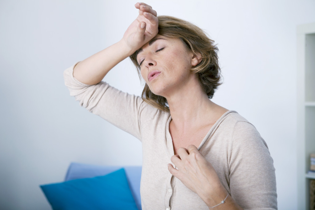 woman experiencing hot flashes