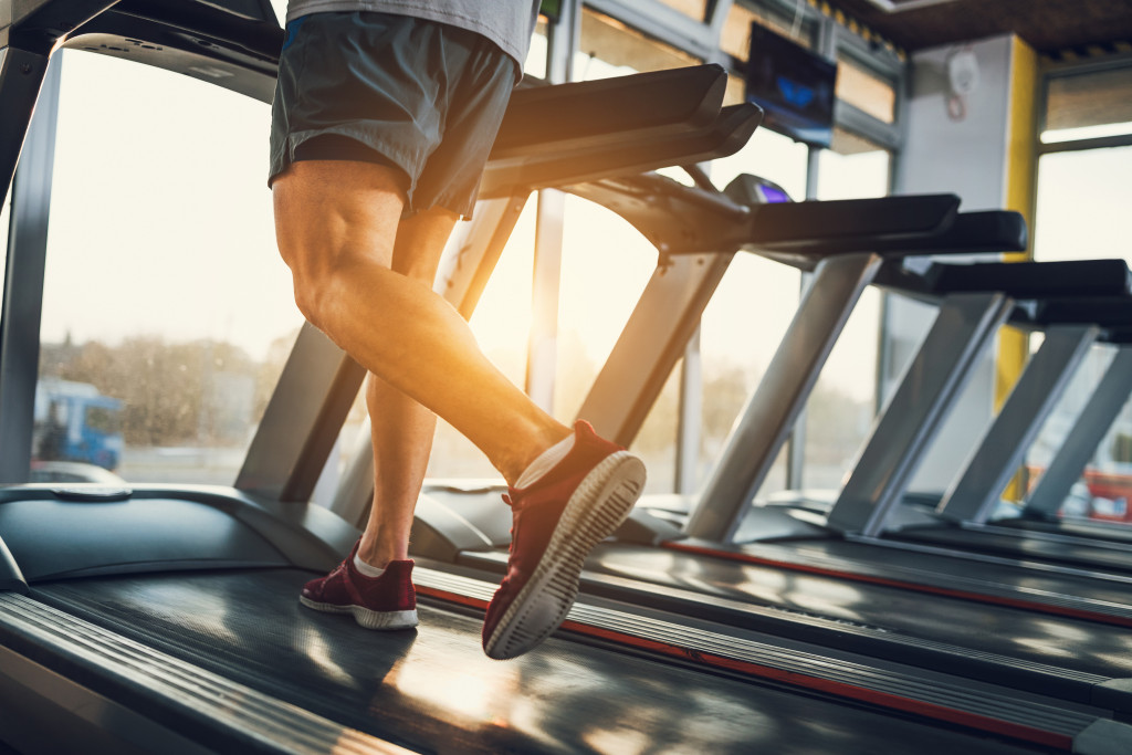 man using a treadmill in gym