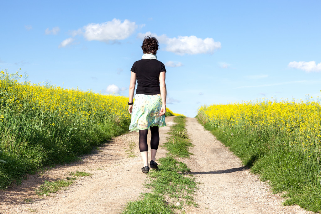 woman in her tights walking across the field