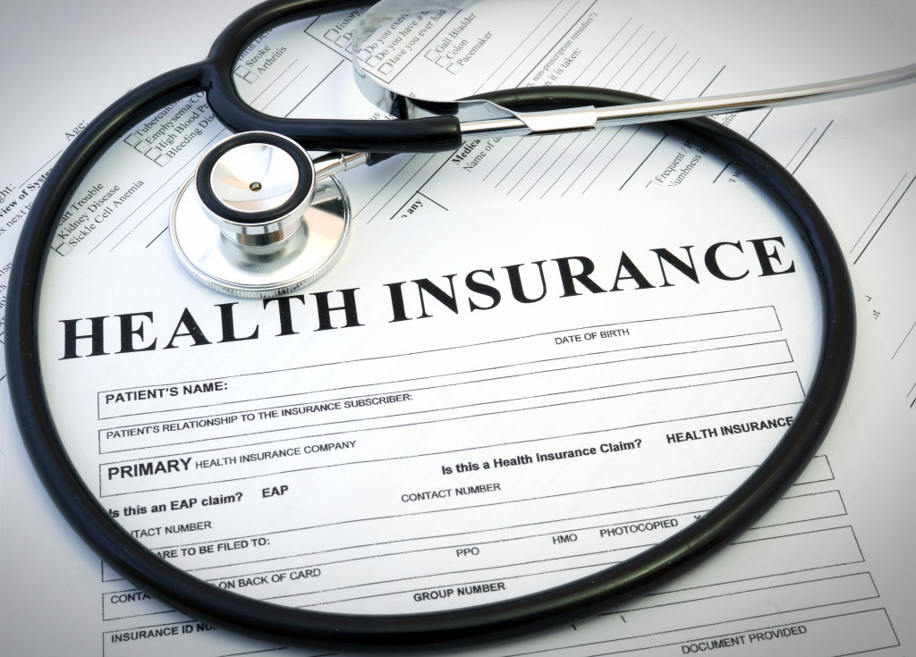 health insurance document with stethoscope on top of it