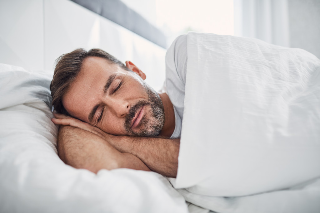 man sleeping peacefully on his bed
