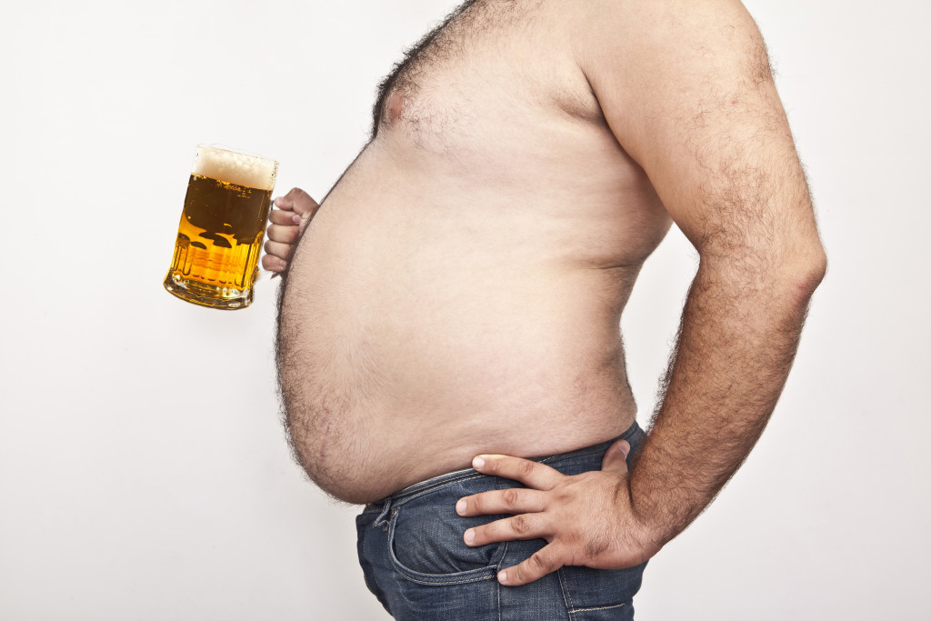 man with big belly drinking beer
