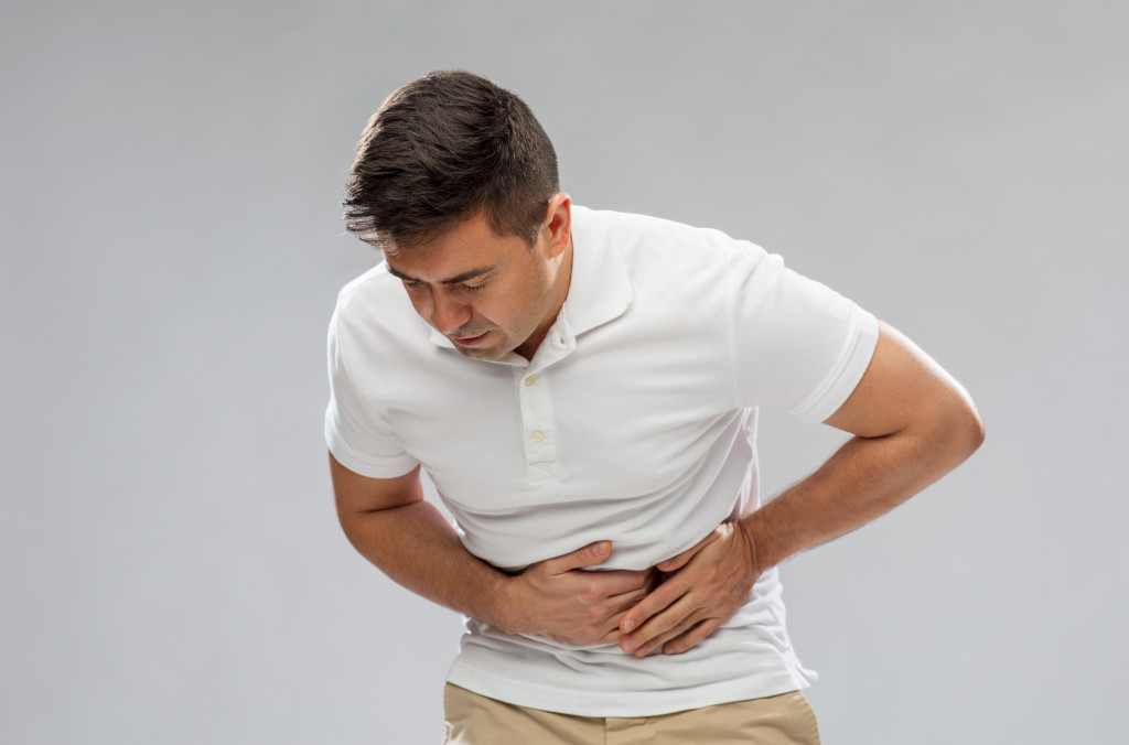 A healthy adult experiencing sharp abdominal pain
