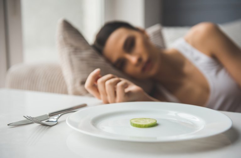 woman with a plate with cucumber